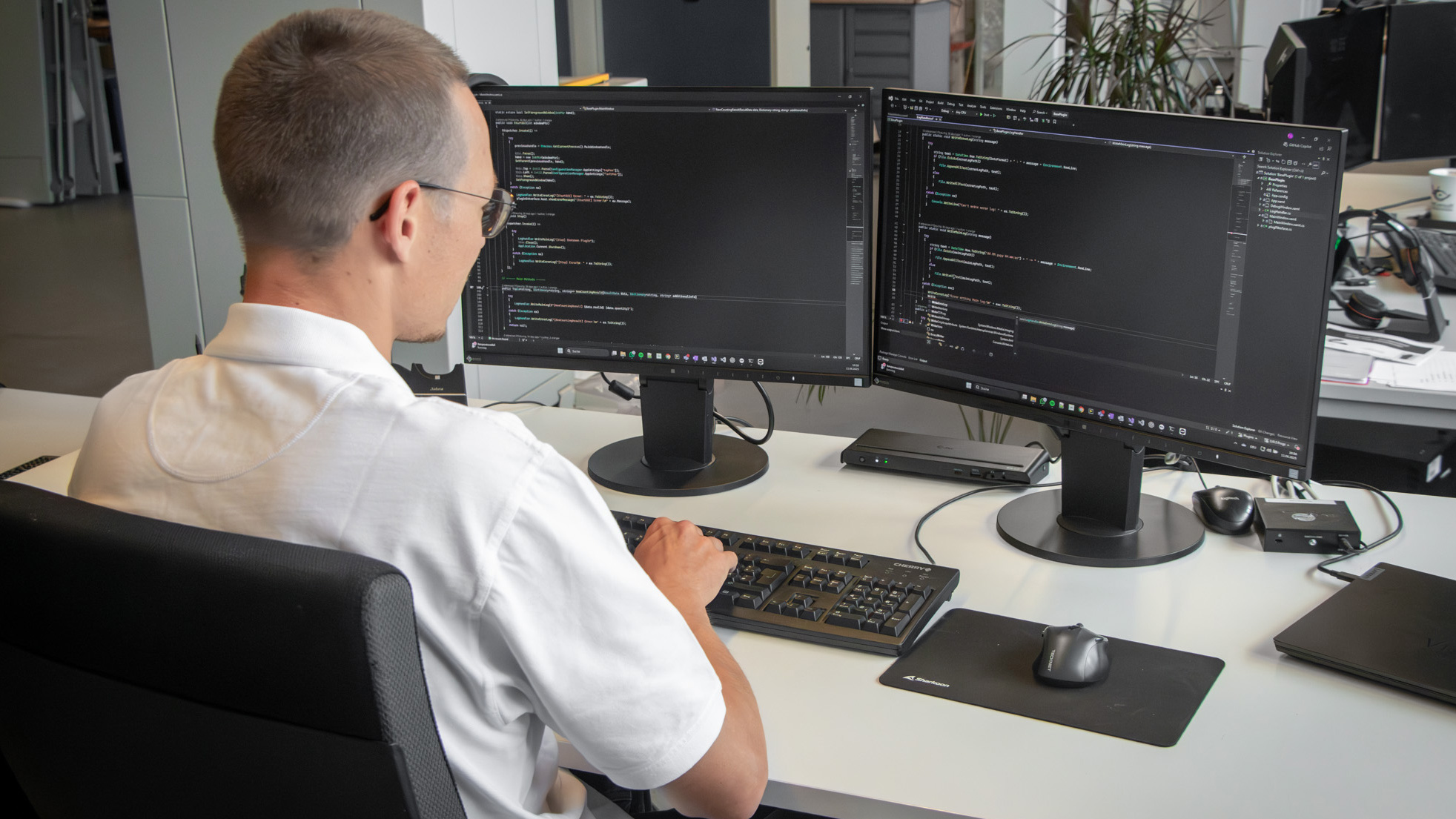 VCcount team member who is checking codes on two screens